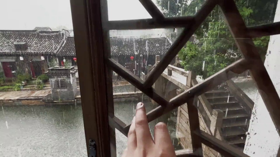 从木质花窗内向外看雨天江南水乡雨景