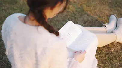 在草地上看书的女生